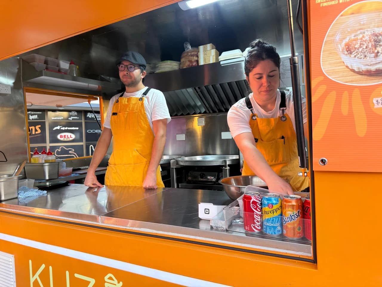 Okan and Burcu serving customers from the window of the Kuzine Turkish Street Food truck