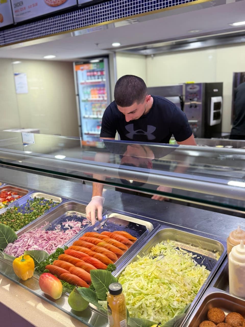 Muhammad Ali working behind the Ozi Yiros counter.