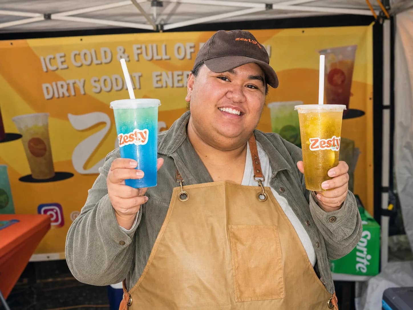 Claudia holding two drinks at the Zesty Cup stall in Woodridge