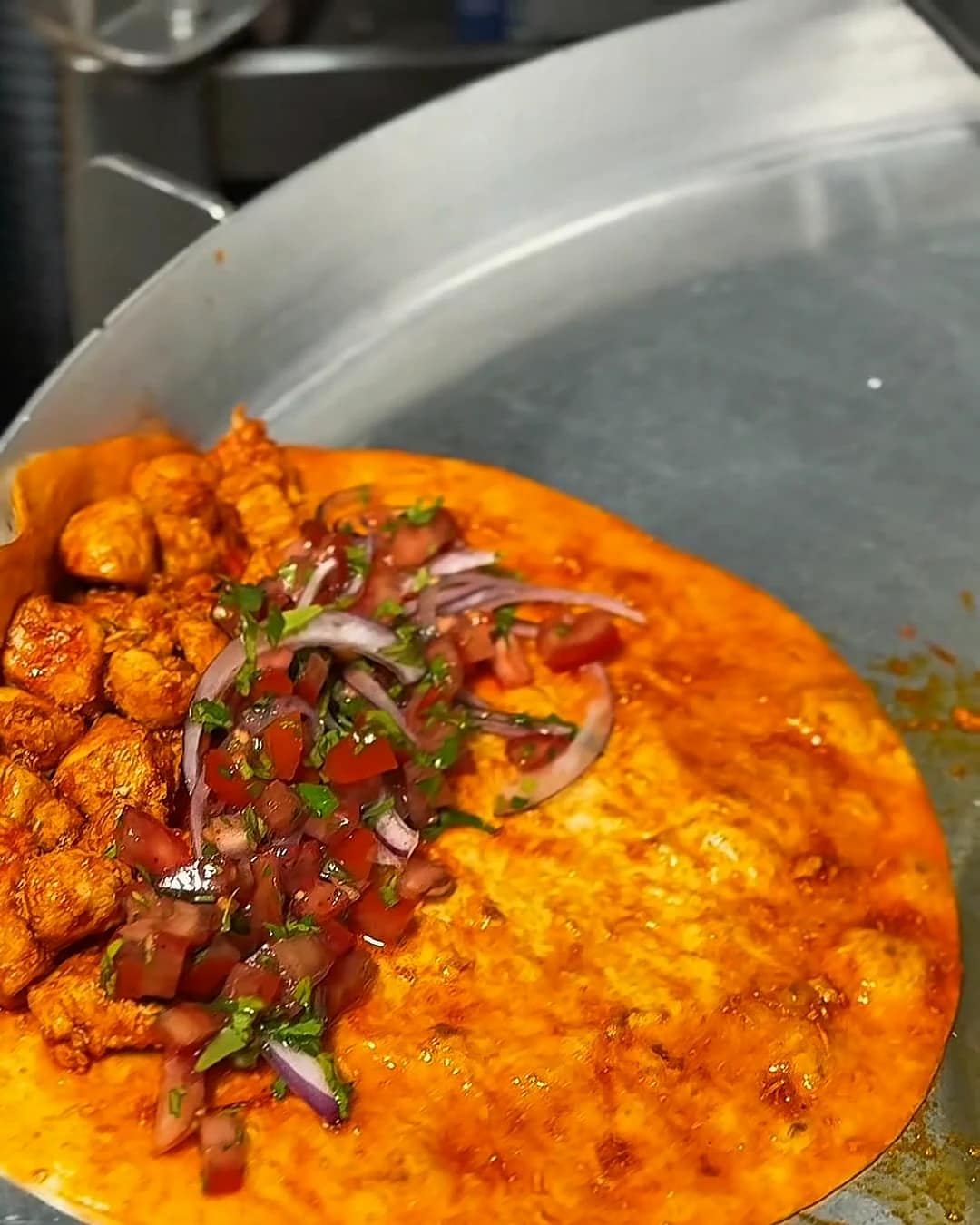 Tantuni being finished on Kuzine's domed pan inside the mobile food truck