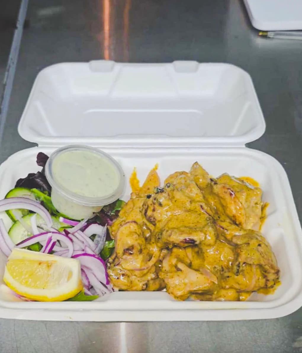 Creamy tandoori entree served with salad and mint sauce at Punjabi Bytes