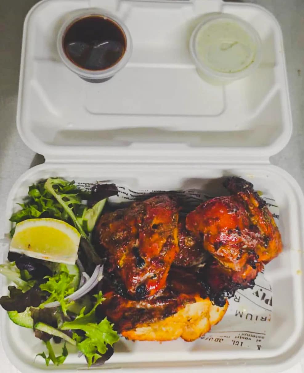 Tandoori chicken served with salad and mint sauce at Punjabi Bytes