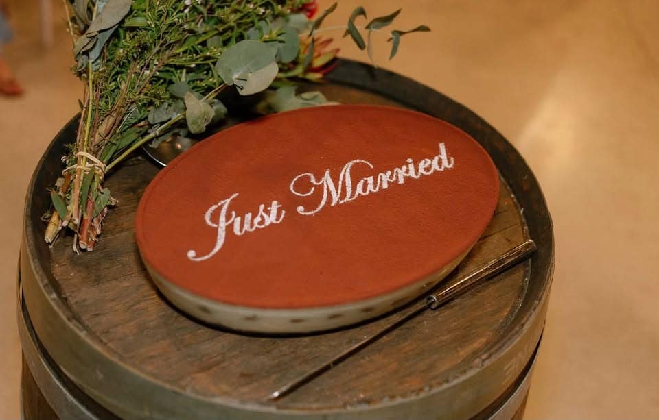 A "Just Married" tiramisu on a wine barrel with native flowers