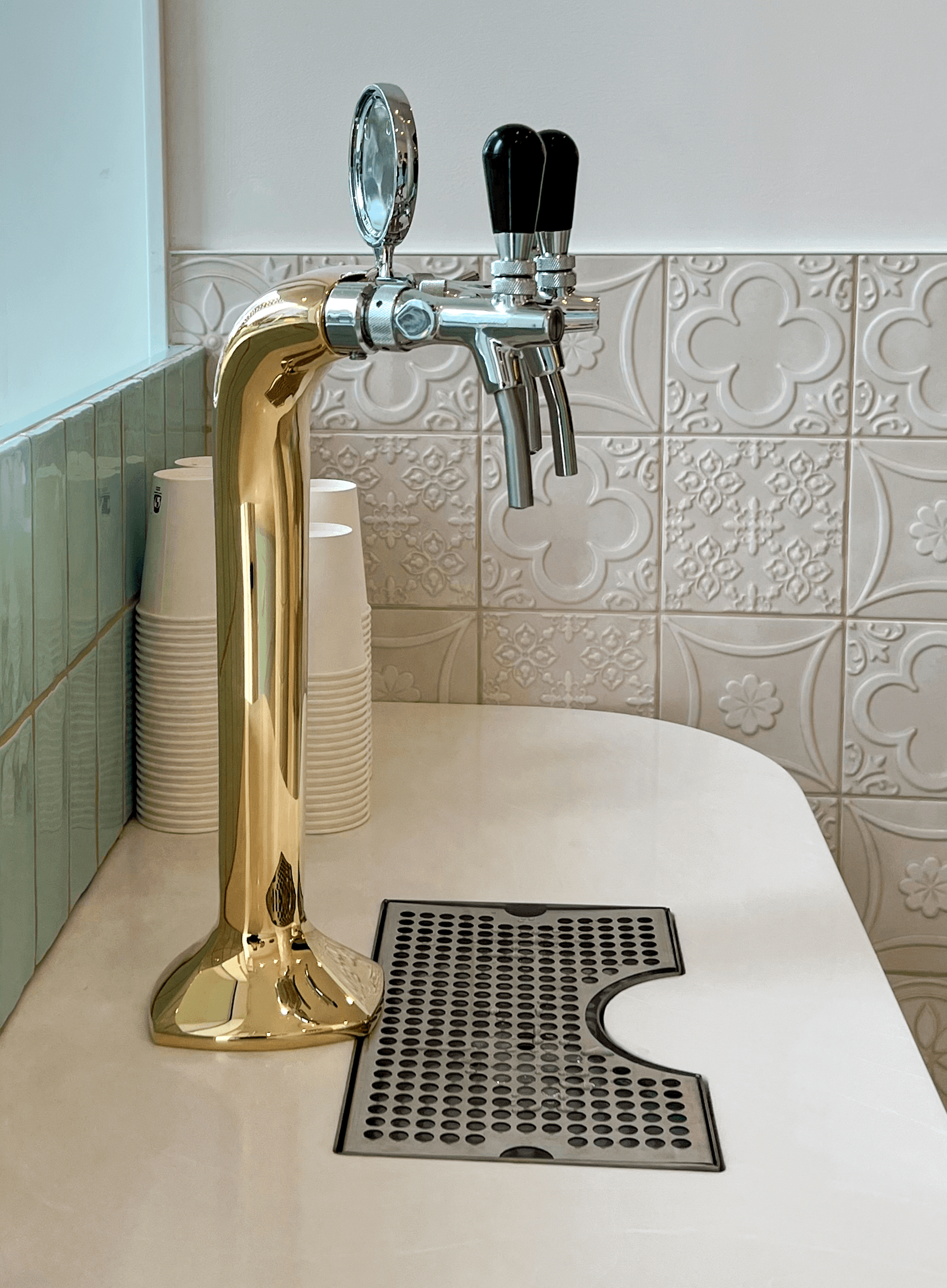 A gold-coloured tap at the separate sparkling-water station inside Luma Newstead