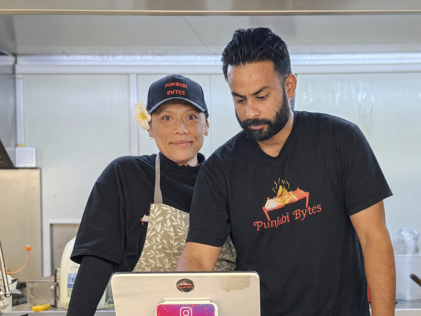 Punjabi Bytes owners Sarah Nikola and Satinder Singh inside their Woodridge food trailer