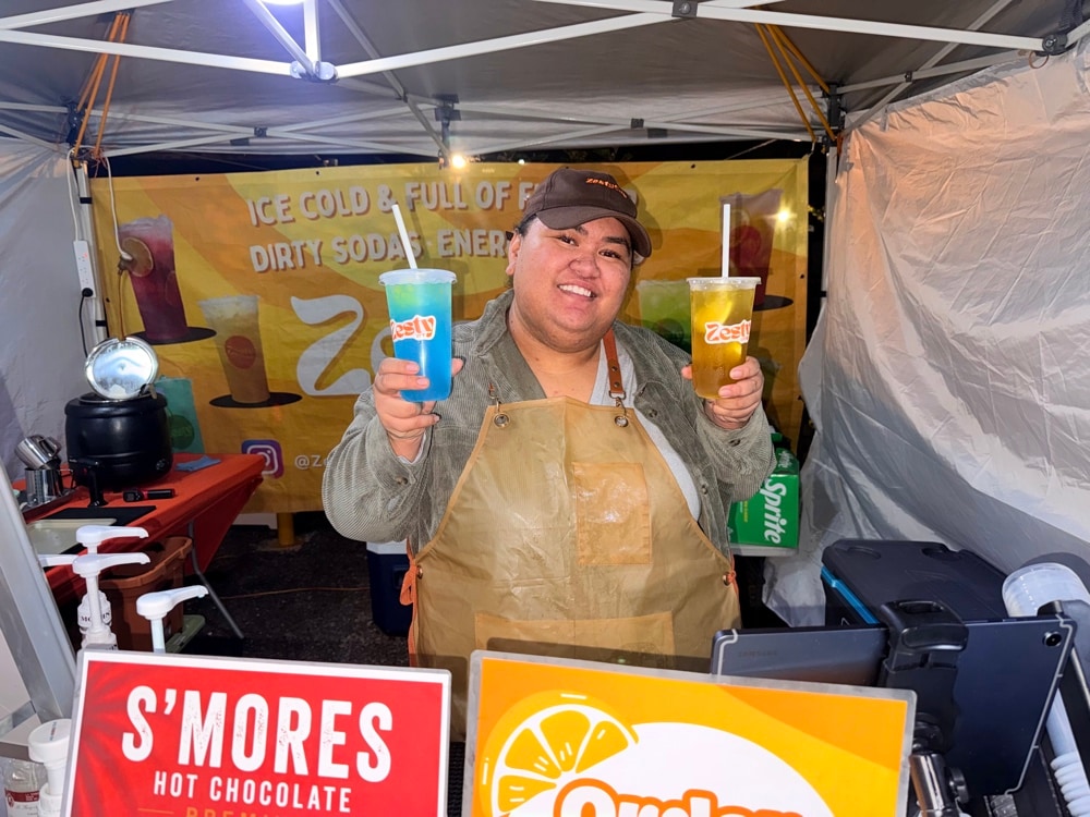 Claudia holding Zesty Bestie and Blue Me Away at the Zesty Cup stall