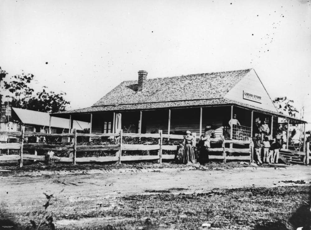 Logan Store near the Logan River with people gathered outside around 1872