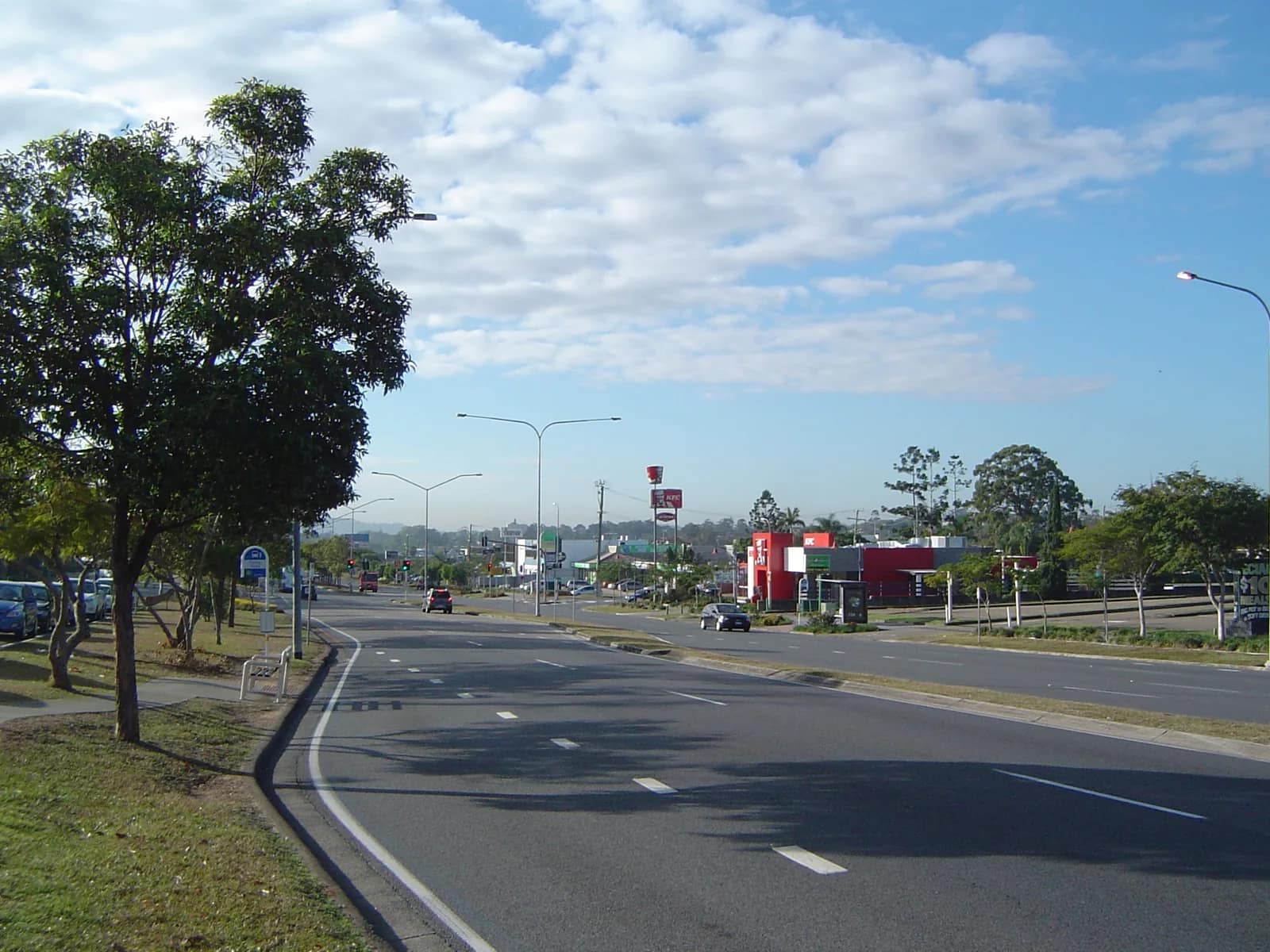 Wembley Road running through Logan Central beneath a broad blue sky