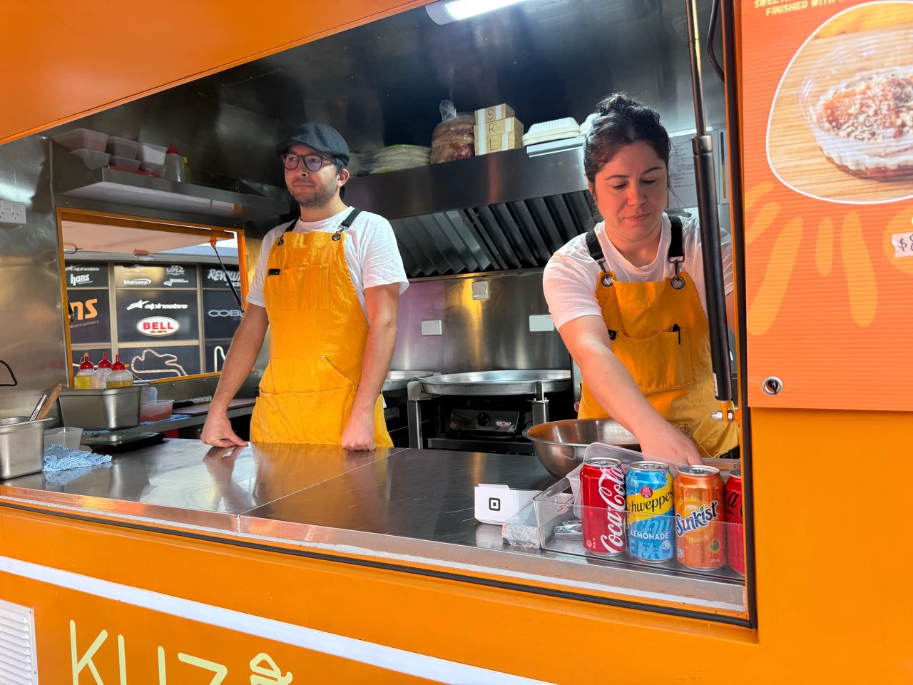 Okan and Burcu serving from the window of the Kuzine Turkish Street Food truck
