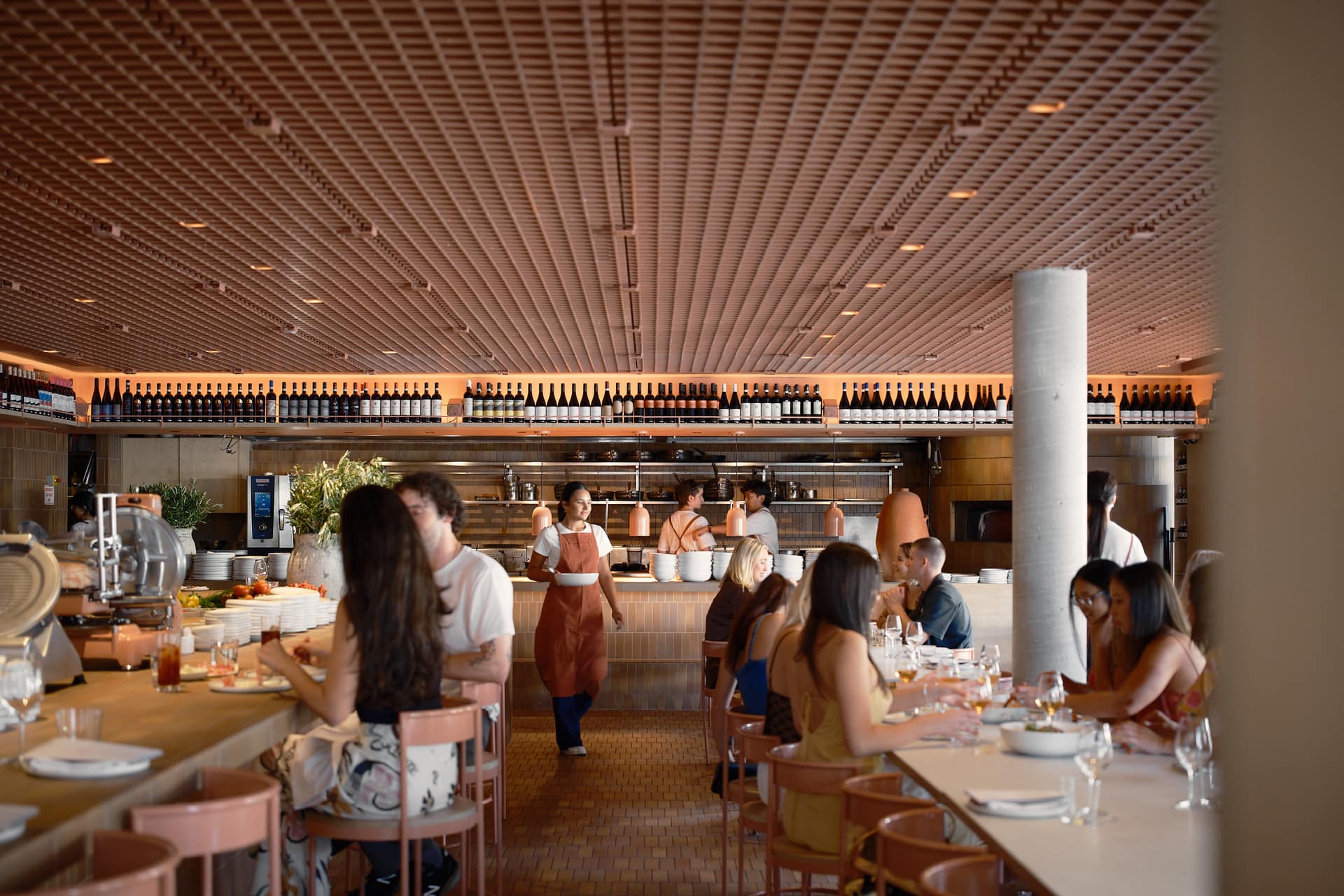 Guests and staff in Biànca’s warm pink dining room