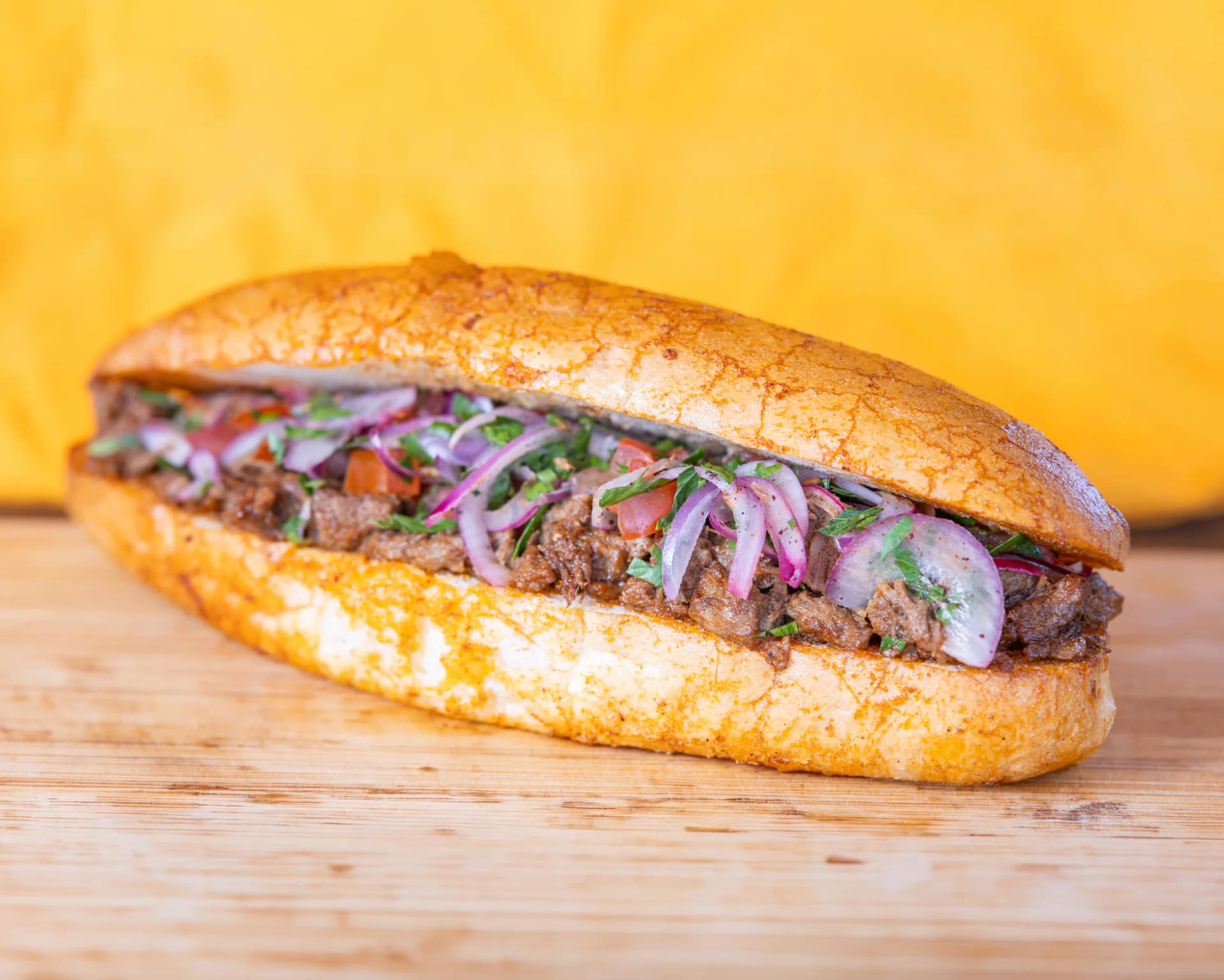 Beef tantuni bread roll with tomato, red onion and parsley from Kuzine Turkish Street Food