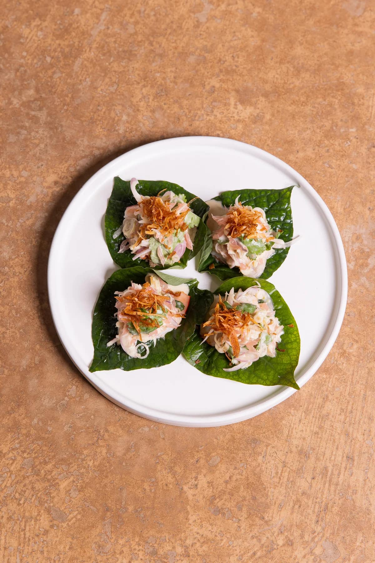 Four betel-leaf bites served at sAme sAme