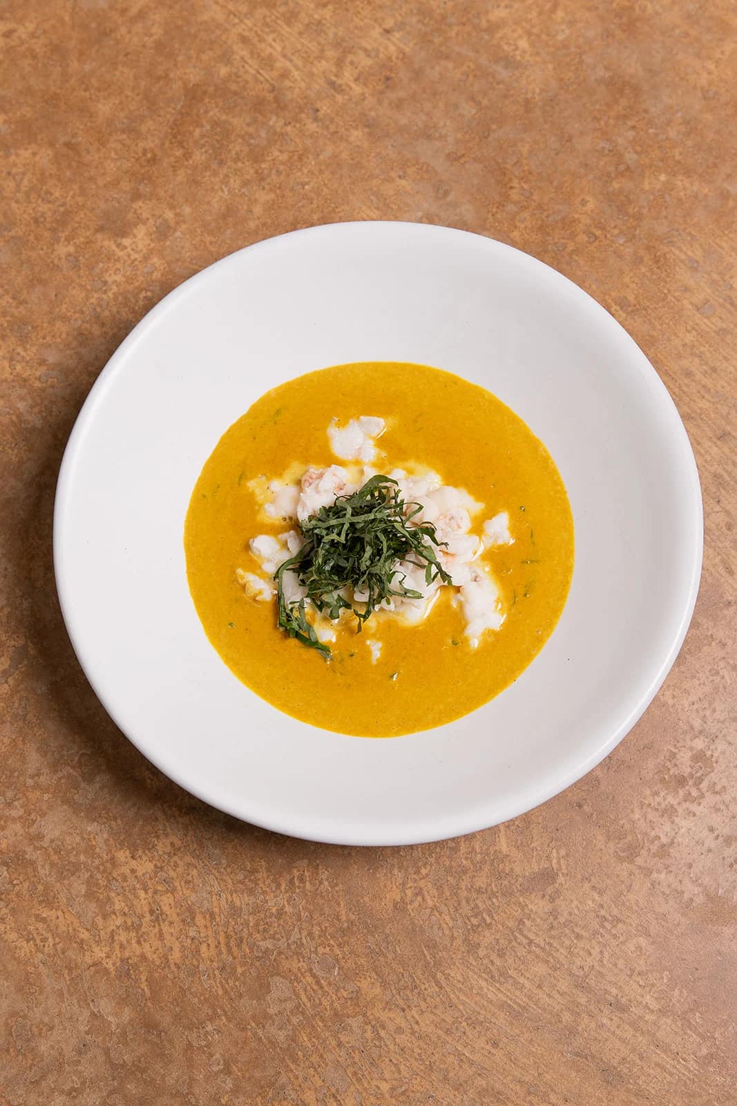 An orange curry served at sAme sAme