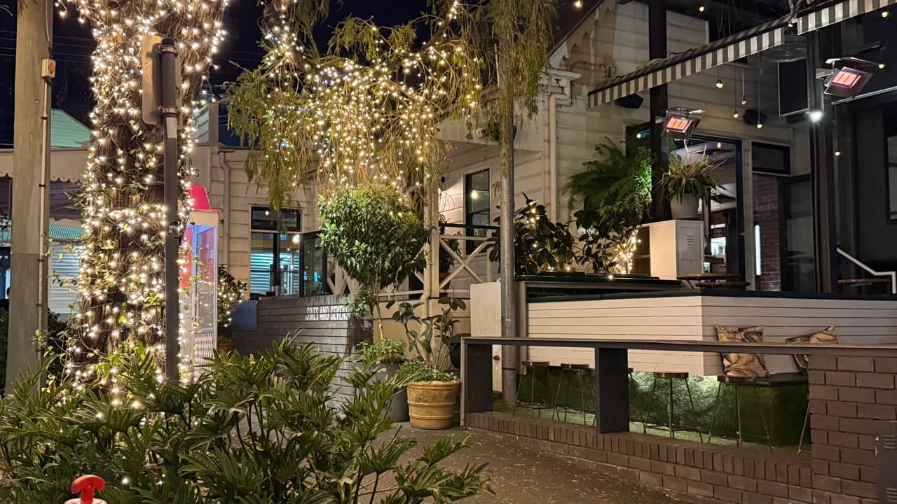 At Sixes and Sevens terrace and James Street trees lit up at night