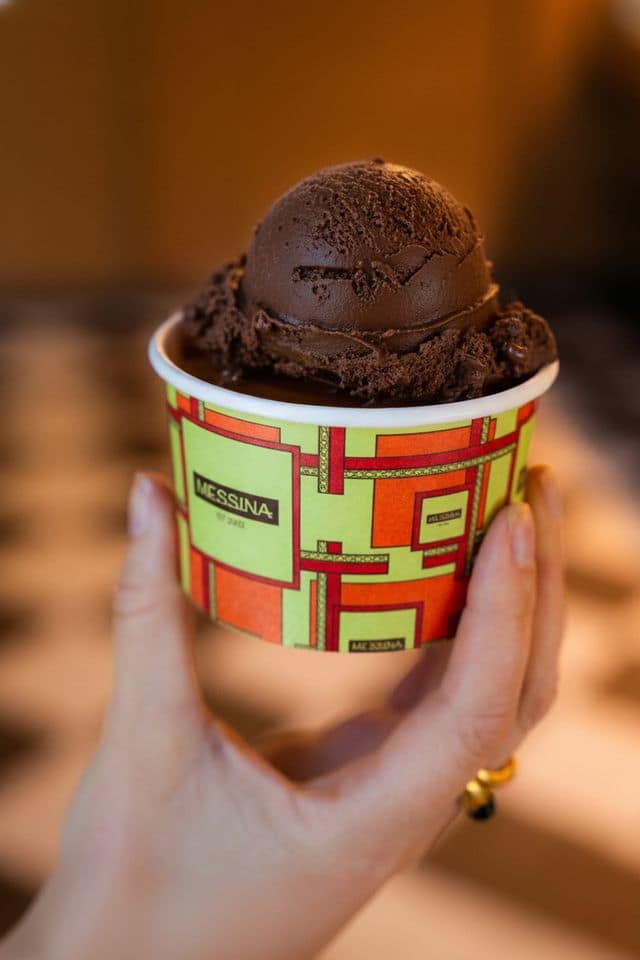 A scoop of chocolate gelato in a Gelato Messina cup